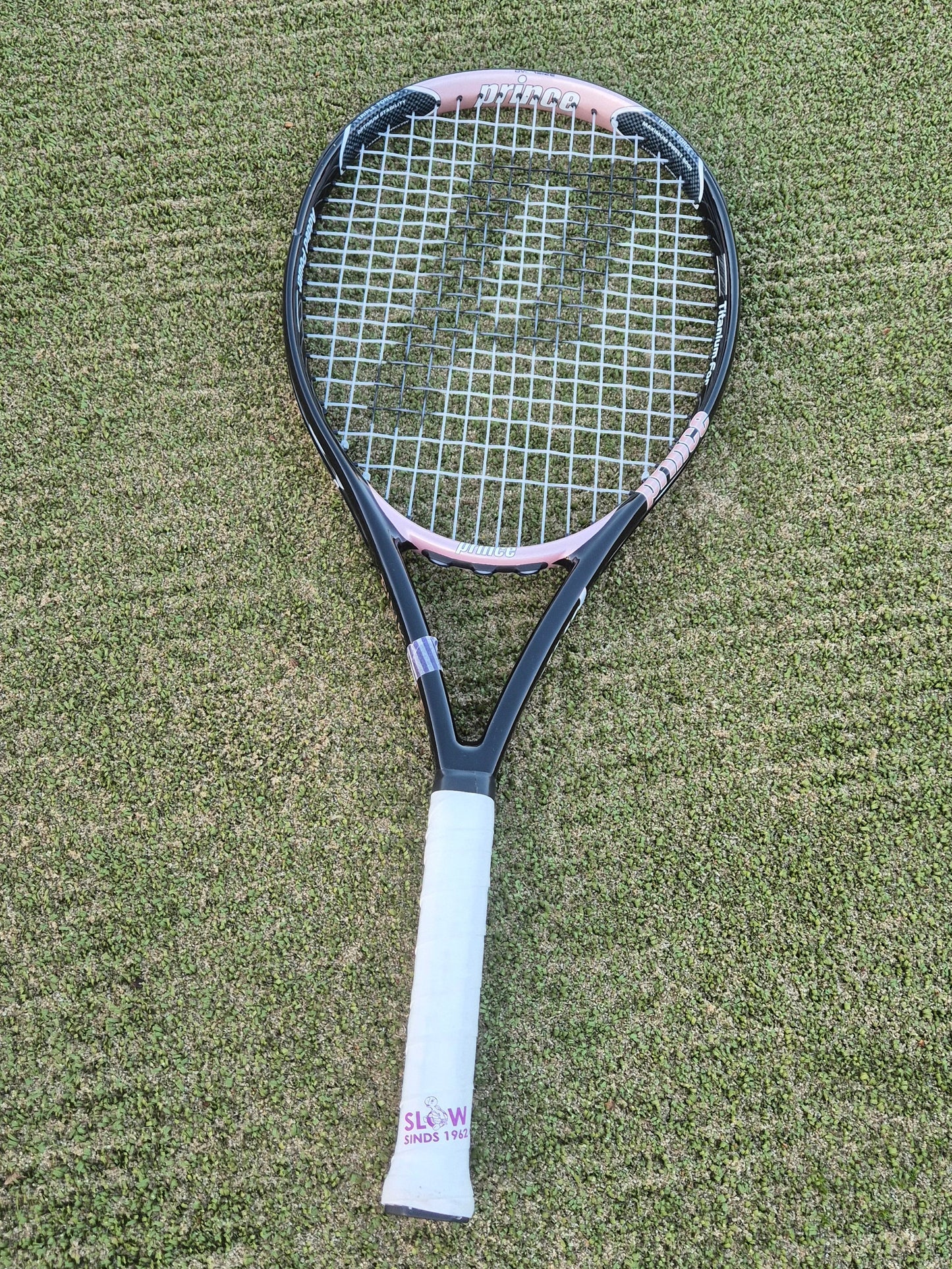 Tennis racket on a grass tennis court